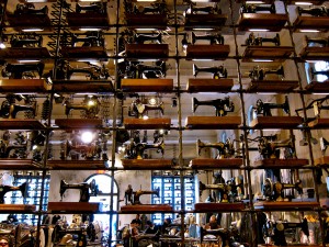 Vintage sewing machines make up a full wall.