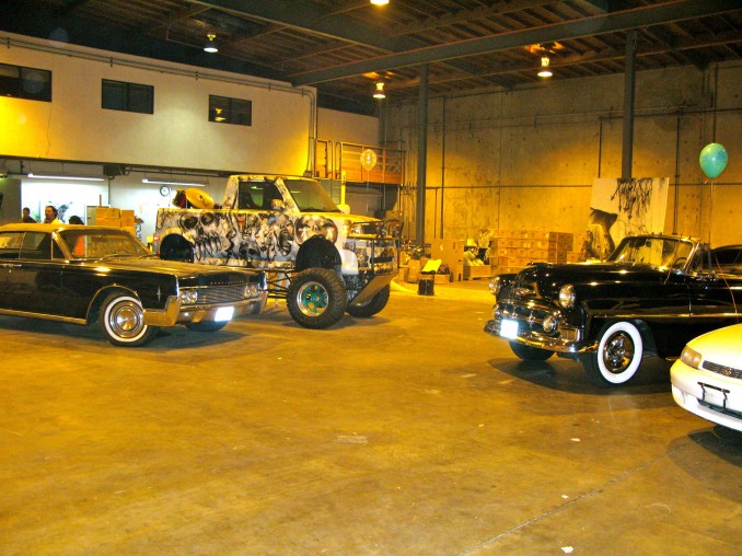 davidchoe3 David Choe's massive studio space in downtown where i had the pleasure of visiting a couple times during my trip to la. This is his amazing car colection on display. The best one by far the custom toyota truck he painted for Scion during Art Basel Miami 2006. I watched that bad boy go up ocean drive 4 yrs ago and it still looks just as cool.